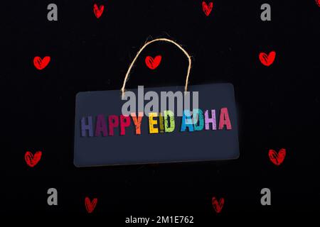 Rectangular shaped black notice board and red hearts on black background Stock Photo