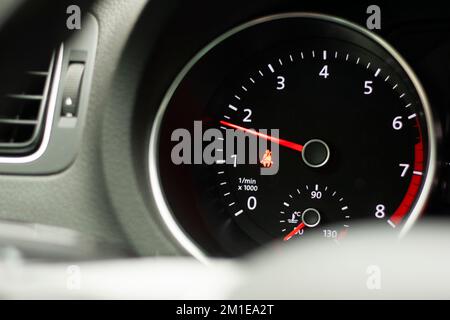 Odometer, rev counter and different vehicle or car controls, as well as climate control controls, lights, multifunction display, seat belt alert or ga Stock Photo