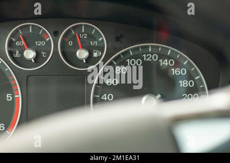 Odometer, rev counter and different vehicle or car controls, as well as climate control controls, lights, multifunction display, seat belt alert or ga Stock Photo