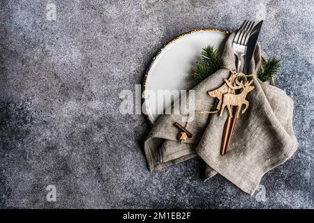 Overhead view of a Christmas place setting with reindeer and Christmas tree ornaments Stock Photo