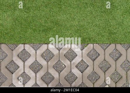 Top view of artificial grass and cobblestones Stock Photo