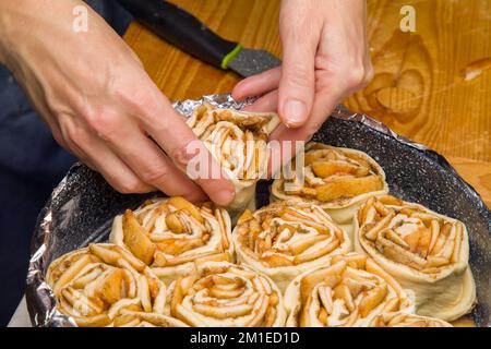 Cooking Process. Pie Made With Homemade Apples in Shape of Rose in Baking Dish Stock Photo