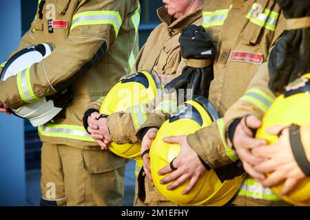 Fireman showing respect holding his helmet Stock Photo