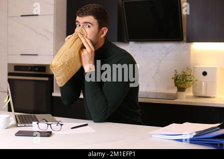 Man having a mental breakdown while working from home Stock Photo