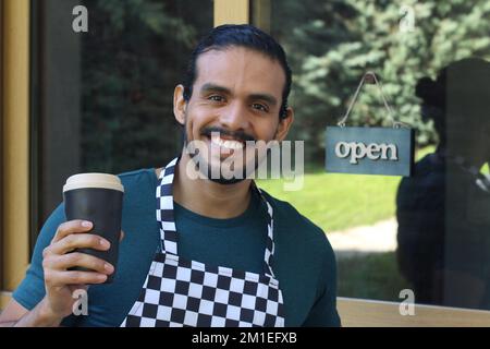 Barista in front of business entrance Stock Photo