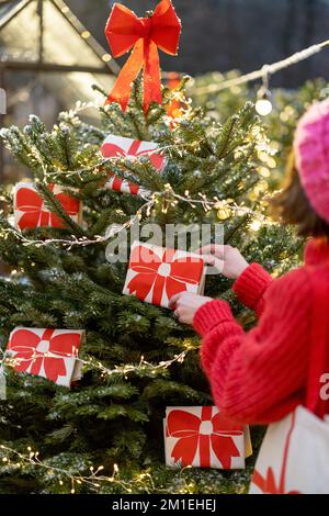 Decorates Christmas tree with big red bows Stock Photo