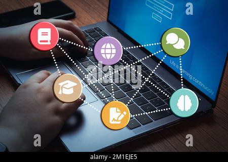 Young woman using laptop for online class. E-learning concept with colorful illustrative icons. Personal development. Distance education. Stock Photo