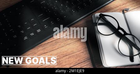 Banner of vintage desktop view with new goals text and copy space. Planning new goals to reach this next year. Achievements, aspirations and wishes. Stock Photo