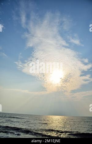 Sun behind clouds, Bhagal beach, Valsad, Gujarat, India, Asia Stock Photo