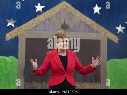 First Minister of Scotland Nicola Sturgeon chats to pupils before unveiling her 2022 Christmas card during her visit to Sunnyside Primary School in Glasgow where children at the school were involved in a competition to create the design. Picture date: Monday December 12, 2022. Stock Photo