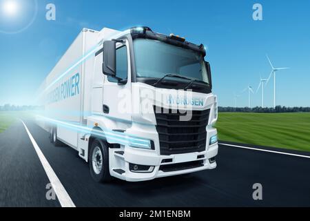 Hydrogen fuel cell semi truck on a road with wind turbines on a horizon. Eco-friendly commercial vehicle concept Stock Photo