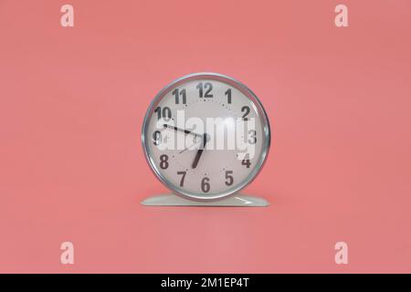 White retro alarm clock without external bell. isolated on pink background. Stock Photo