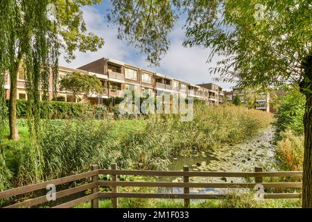 an apartment complex with water and trees in the foreground area, brisbane, queensland, australia - stock photo Stock Photo