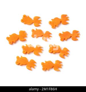 Collection of cut out goldfishes from fresh raw sweet winter carrot with a metallic mold  for decoration isolated on white background Stock Photo