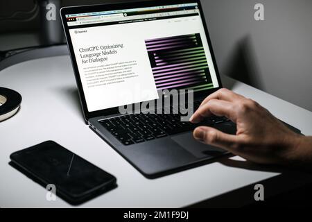 Screen with ChatGPT chat with AI or artificial intelligence. Man search for information using artificial intelligence chatbot developed by OpenAI Stock Photo