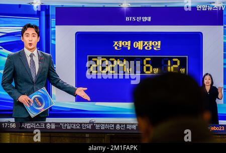 Jin's discharge date from the army seen on TV at Yongsan Railway Station in Seoul. Jin, the member of the K-pop group BTS to serve in the military, has released a photo of himself with a military haircut ahead of his enlistment. The 30-year-old vocalist will enter a boot camp of a front-line Army 5 division in Yeoncheon, 60 kilometers north of Seoul, on 13 December, according to military and industry sources. After undergoing a five-week basic training program, Jin will be assigned to a local unit, they said. All South Korea able-bodied men are obliged to serve between 18 and 21 months in the Stock Photo