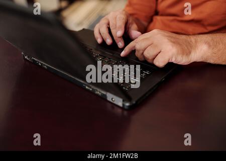Hands of senior man working on laptop Stock Photo