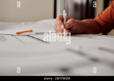 Senior man working on constructing plan of his new house Stock Photo