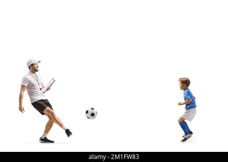 Football coach with a whistle holding a clipboard and training with a boy isolated on white background Stock Photo