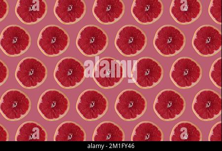 Cut grapefruit slices isolated on pink background. Citrus concept idea. Stock Photo