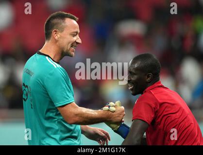 Team A's John Terry congratulates a goalkeeper during a Workers and FIFA Legends Match at the Al Thumama Stadium, Doha, Qatar. Picture date: Monday December 12, 2022. Stock Photo