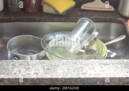 Dirty dishes, dishes, cutlery and dirty pots in a simple home sink,real life concept. Stock Photo