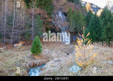 Small waterfall and stream in Morteratsch Valley, Switzerland in autumn Stock Photo