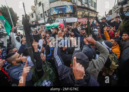 Jenin, Palestine. 12th Dec, 2022. Mourners and gunmen carry the body of 15-year-old Palestinian Jana Zakarneh in the city of Jenin in the occupied West Bank. Jana was shot dead by the Israeli army while she was on the roof of her house, during an army raid on the city. (Photo by Nasser Ishtayeh/SOPA Images/Sipa USA) Credit: Sipa USA/Alamy Live News Stock Photo
