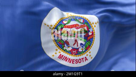 The US state flag of Minnesota waving in the wind. Minnesotais a state in the upper midwestern region of the United States. Rippled textile background