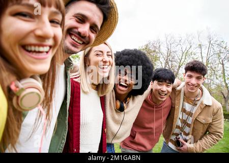 Portrait of mixed race group of smiling friends looking at the camera. Young students take a selfie Stock Photo