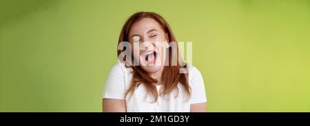 Lazy weekends finally time sleep. Cheerful redhead middle-aged 50s woman yawning satisfied close eyes feel sleepy wake up early morning wanna take nap Stock Photo