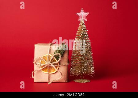 Xmas Background. Fir Tree Branches With Bows, Lollipops And Bells Garland  Framing Gift Box In Craft Wrapping Paper. Christmas Decorations, Preparing  For Winter Holidays Concept, Copy Space, Top View Stock Photo, Picture