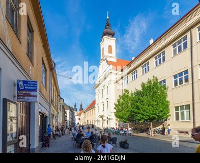 Trnava (Tyrnau): restaurant in Old Town, Kostol svätej Anny (Church of St. Anne) in , , Slovakia Stock Photo