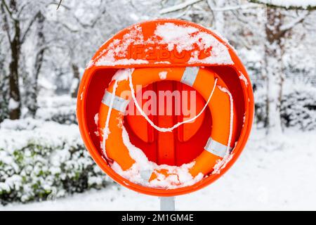 Lifebouy in thick snow near the pond in Alexander Palace.Ready and brightly red coloured with accessibility if there is an emergency or an accident Stock Photo