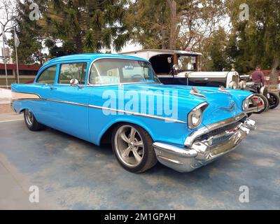 Lanus, Argentina - Sept 25, 2022: Old sky blue 1957 Chevrolet Chevy Bel Air sport sedan two door in the a park. Iconic classic car. Stock Photo