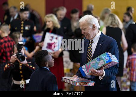 Arlington, United States. 12th Dec, 2022. US President Joe Biden carries toys while participating in a United States Marine Corps Reserve Toys for Tots event at Joint Base Myer-Henderson Hall in Arlington, Virginia, on Monday, December 12, 2022. The Biden's are joining spouses of senior Department of Defense and Service Leadership and local military children in sorting donated toys for distribution to families in need ahead of the holidays. Photo by Al Drago/UPI Credit: UPI/Alamy Live News Stock Photo