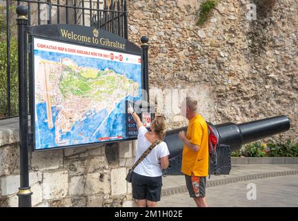 Gibraltar. 22nd October 2022. Older couple looking at a large map of Gibraltar, and pointing to the location of a tourist attraction within it. Stock Photo
