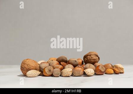 A handful of different nuts on a gray background Stock Photo