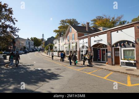 People stroll around the unique shops and boutiques on Bearskin Neck in Rockport, Massachusetts Stock Photo