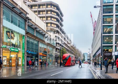 A view along Tottenham Court Road in London, UK on a wet winter's morning in December. Stock Photo