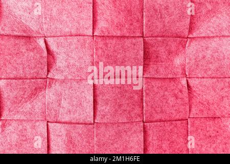 Abstract felt background in trendy color of the year 2023 Viva Magenta. Home storage basket made of soft felt material. Surface of felted wool fabric texture. Closeup, square pattern Stock Photo