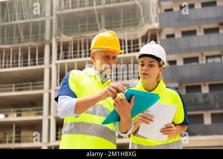 Two qualified engineers are discussing a construction plan Stock Photo