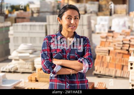 Woman worker posing at building materials warehouse Stock Photo