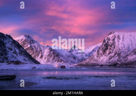 Beautiful snow covered mountains and blue sky with pink clouds Stock Photo
