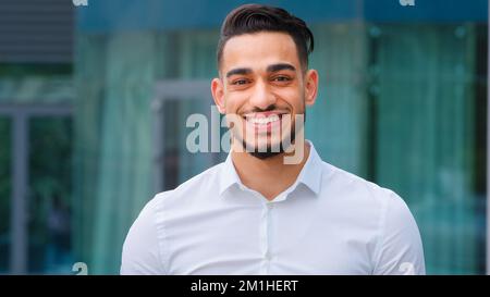 Male portrait happy indian smiling successful adult young man guy bearded businessman boss leader client manager executive entrepreneur wears formal Stock Photo