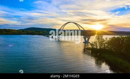 Bridge at sunset with blue skies over water connecting New York to Vermont Stock Photo