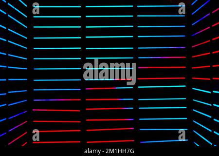 Abstract dark room with horizontal LED poles in blue and red Stock Photo