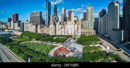 Wide view over Millennium Park with pavilion and line of skyscrapers Stock Photo