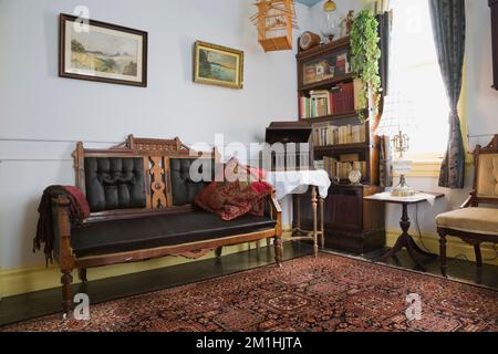 Eastlake upholstered chair and antique furnishings in upstairs room ...