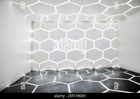 Warped empty white room with octagon LED lights along floor, wall, and ceiling Stock Photo